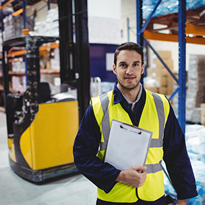 Engineer holding clip board infront of reach truck