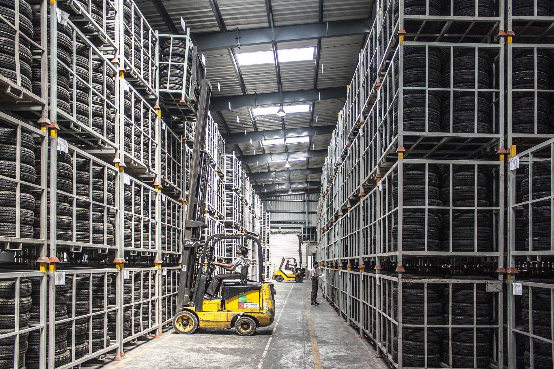 Forklift truck lifting a cage at full reach